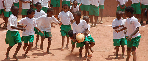 Madagascan children playing with a rugby ball